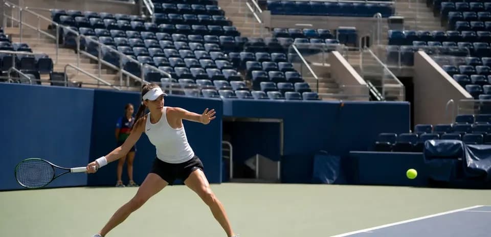 Female tennis player returning a ball during practice