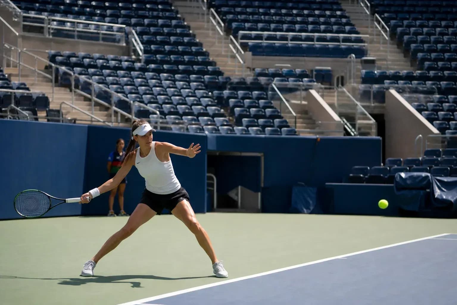 Female tennis player returning a ball during practice