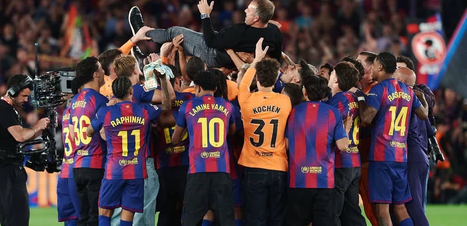 Barcelona players celebrating with their coach after victory