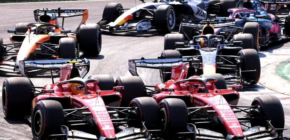 Multiple Formula 1 cars racing closely on track