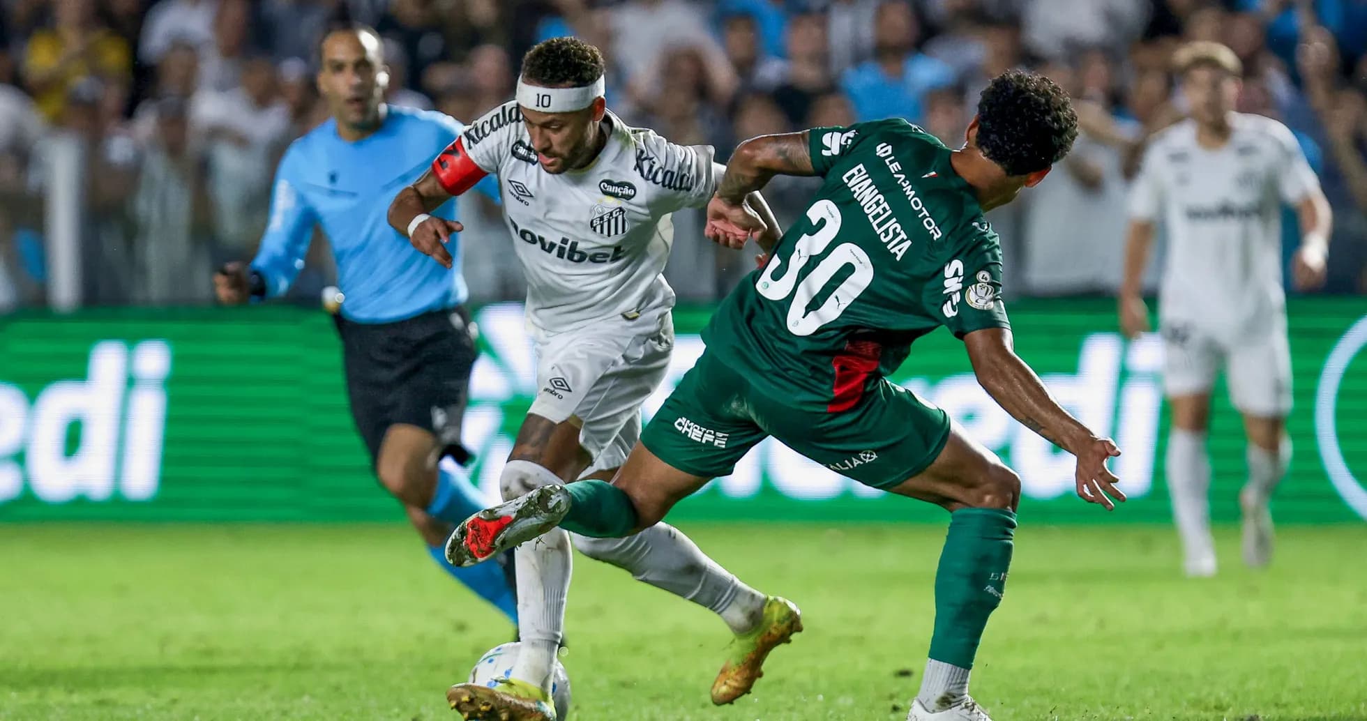 Player in white dribbling past defender in green