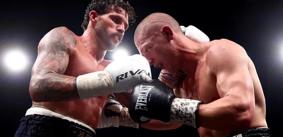 Two boxers engaged in a close fight