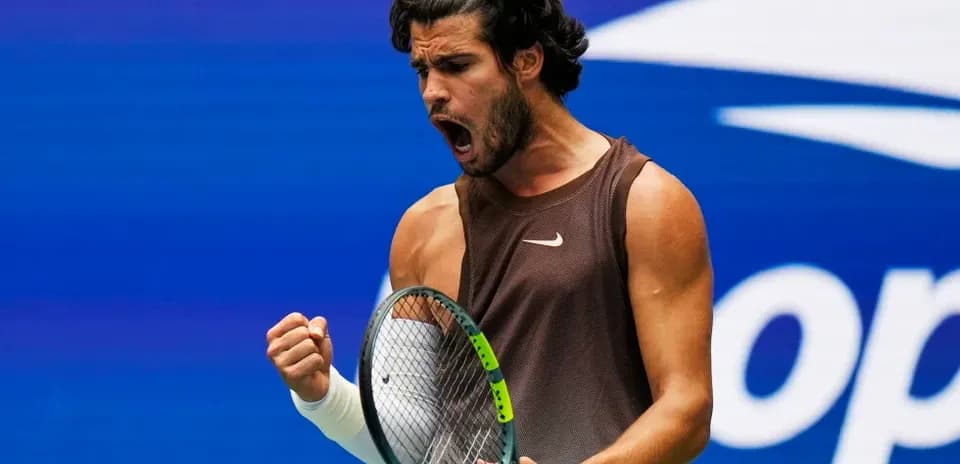 Tennis player celebrating with racket during match