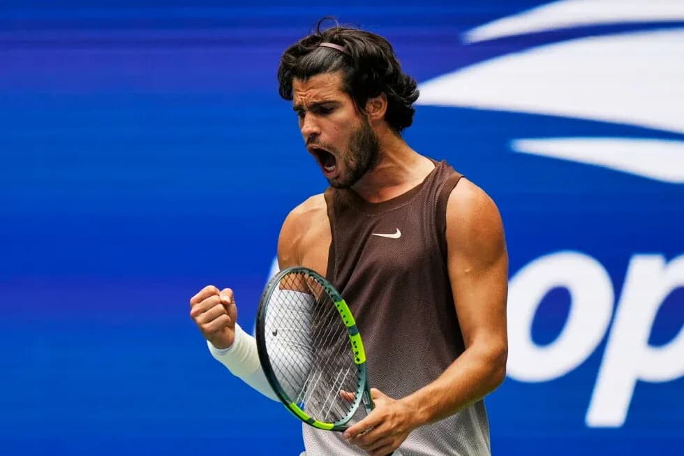 Tennis player celebrating with racket during match