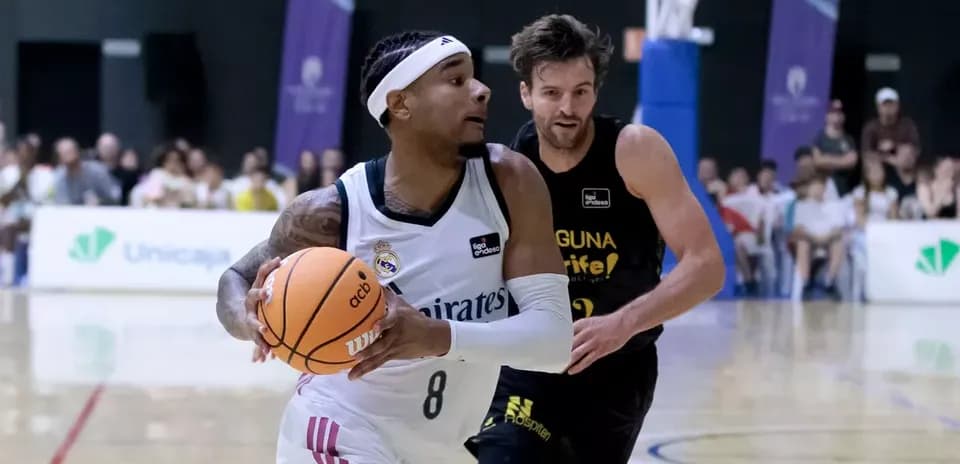 Player dribbling basketball during match against opponent