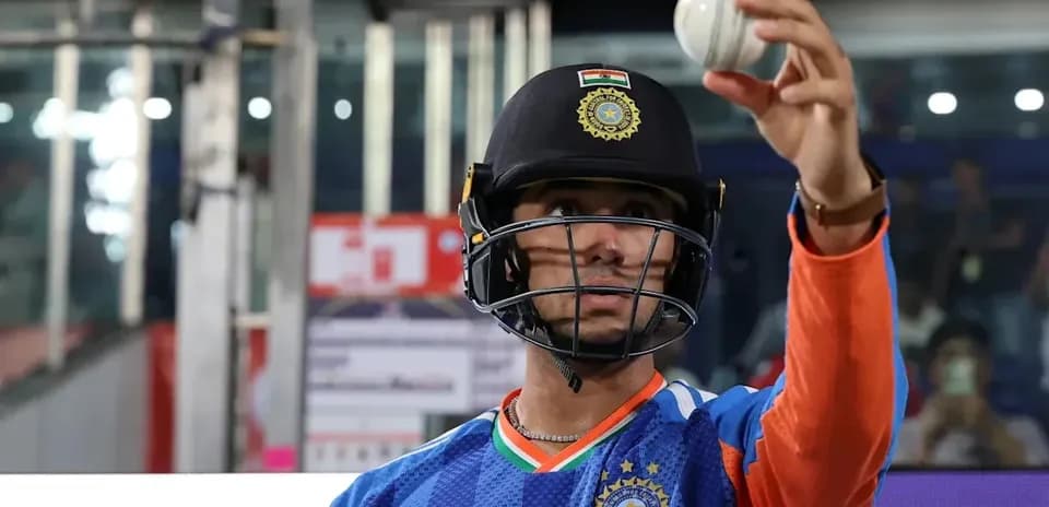 Cricketer in helmet holding a cricket ball