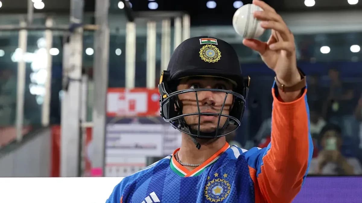 Cricketer in helmet holding a cricket ball
