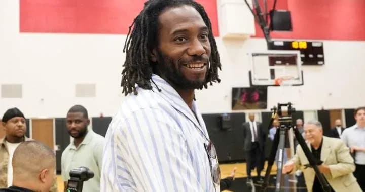 Man smiling at an event in a gym