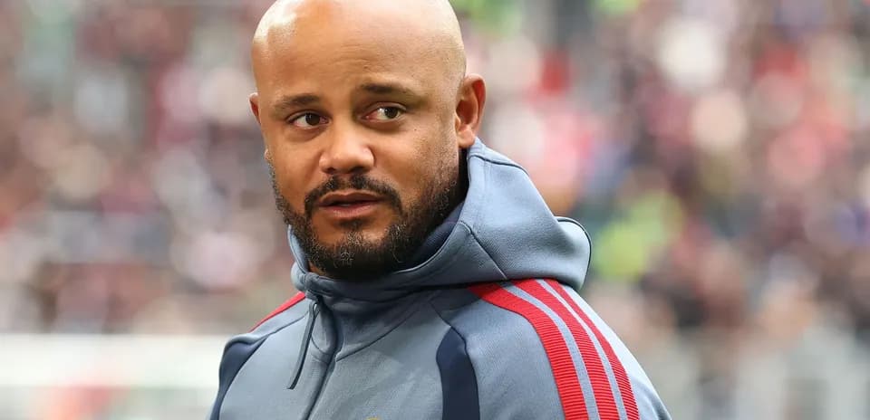 Coach wearing Bayern Munich tracksuit on the sideline