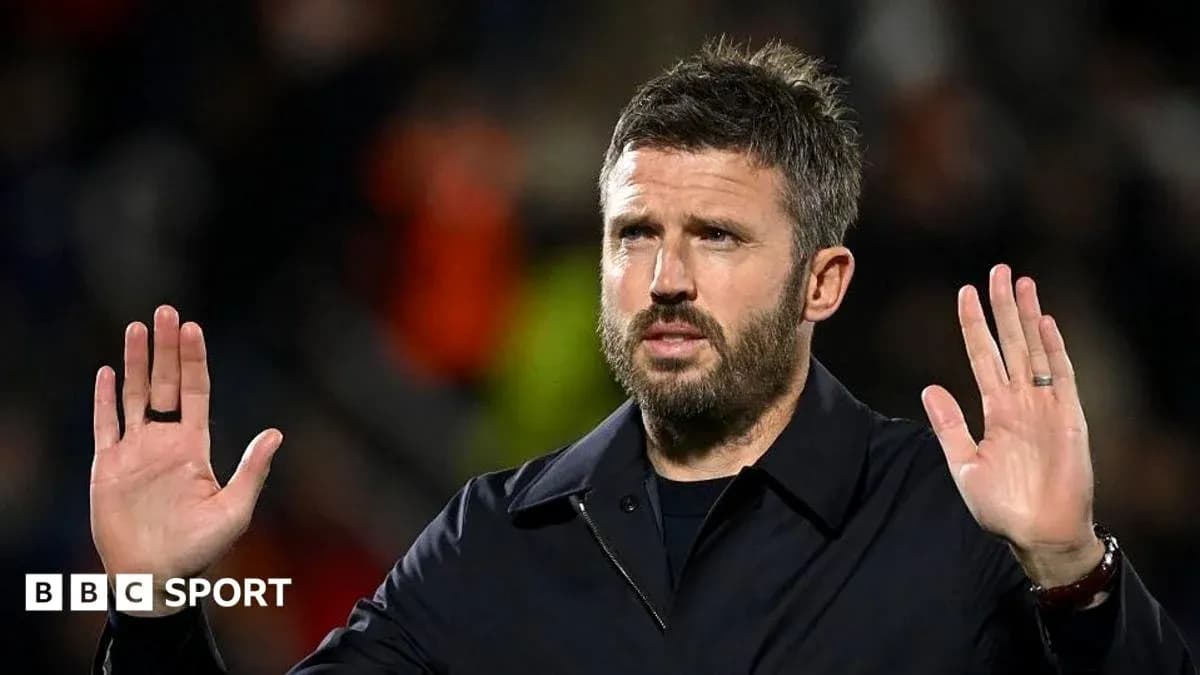 Manager gesturing during a match on the sidelines