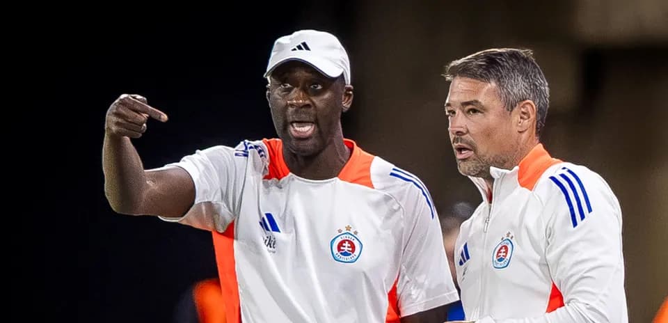 Two coaches discussing strategies during match