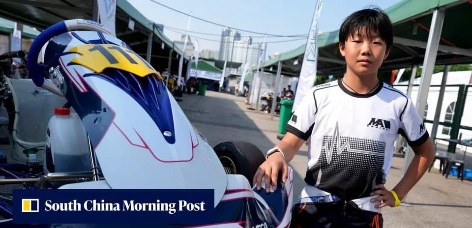 Young driver posing next to go-kart in paddock