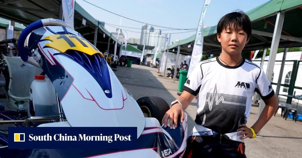 Young driver posing next to go-kart in paddock