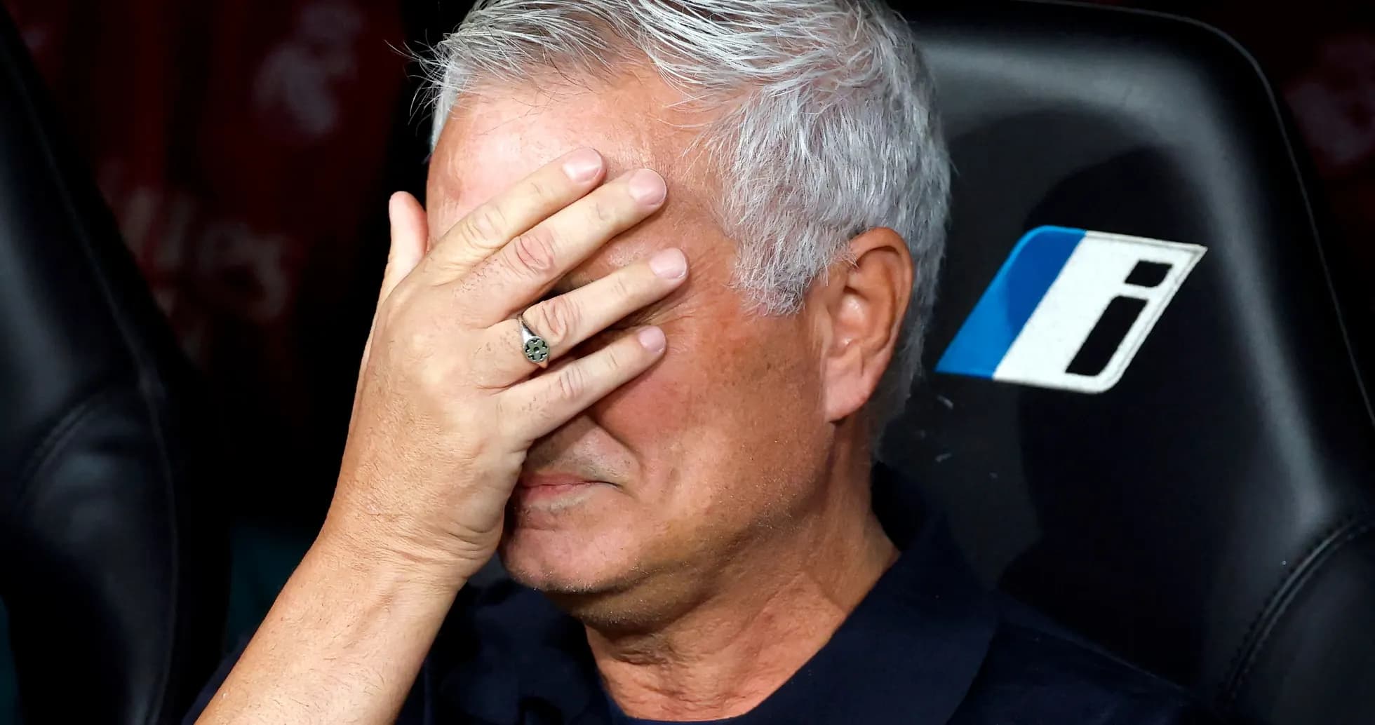 Manager with hand over face on bench