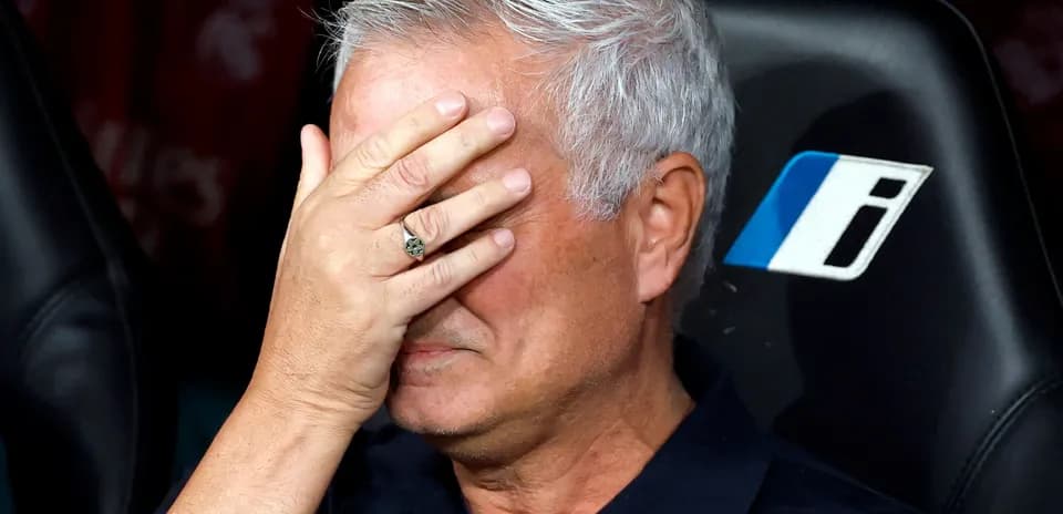 Manager with hand over face on bench