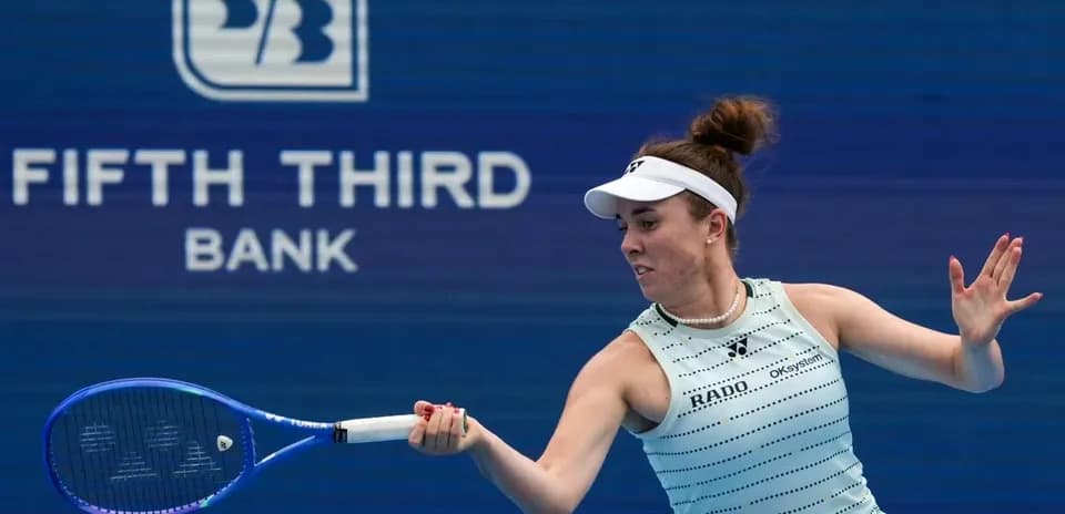 Tennis player hitting a forehand during match