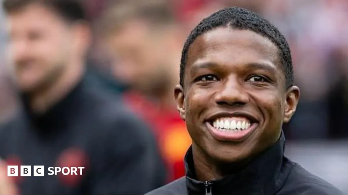 Smiling player in black jacket during warm-up