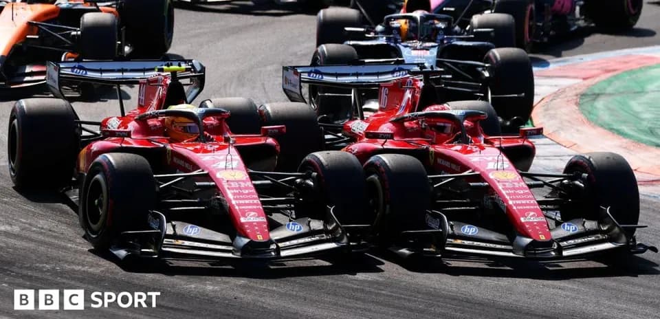 Two Ferrari cars racing closely on track