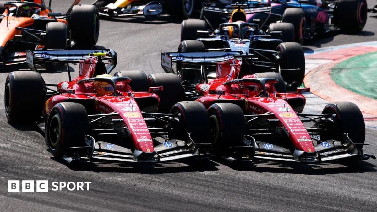 Two Ferrari cars racing closely on track