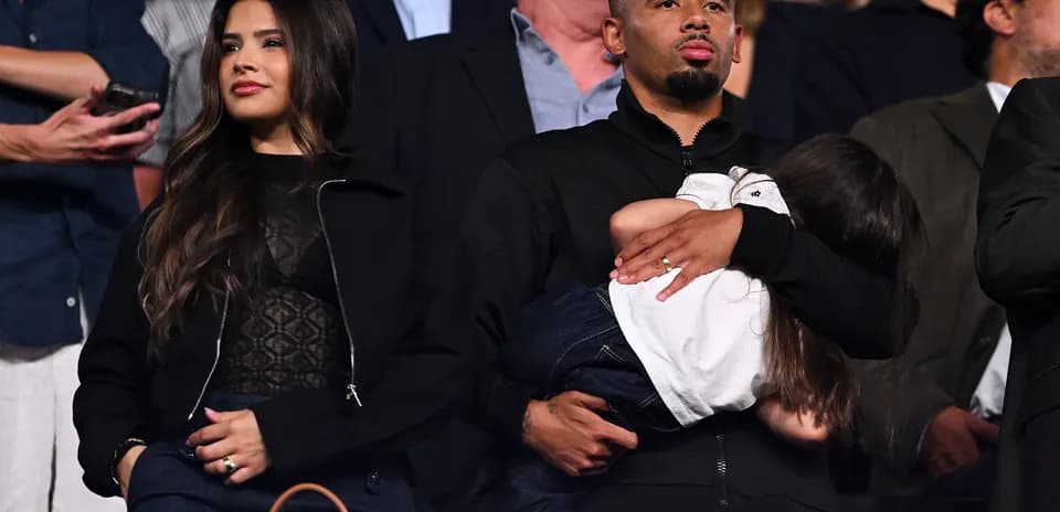 Family attending an event, holding a child