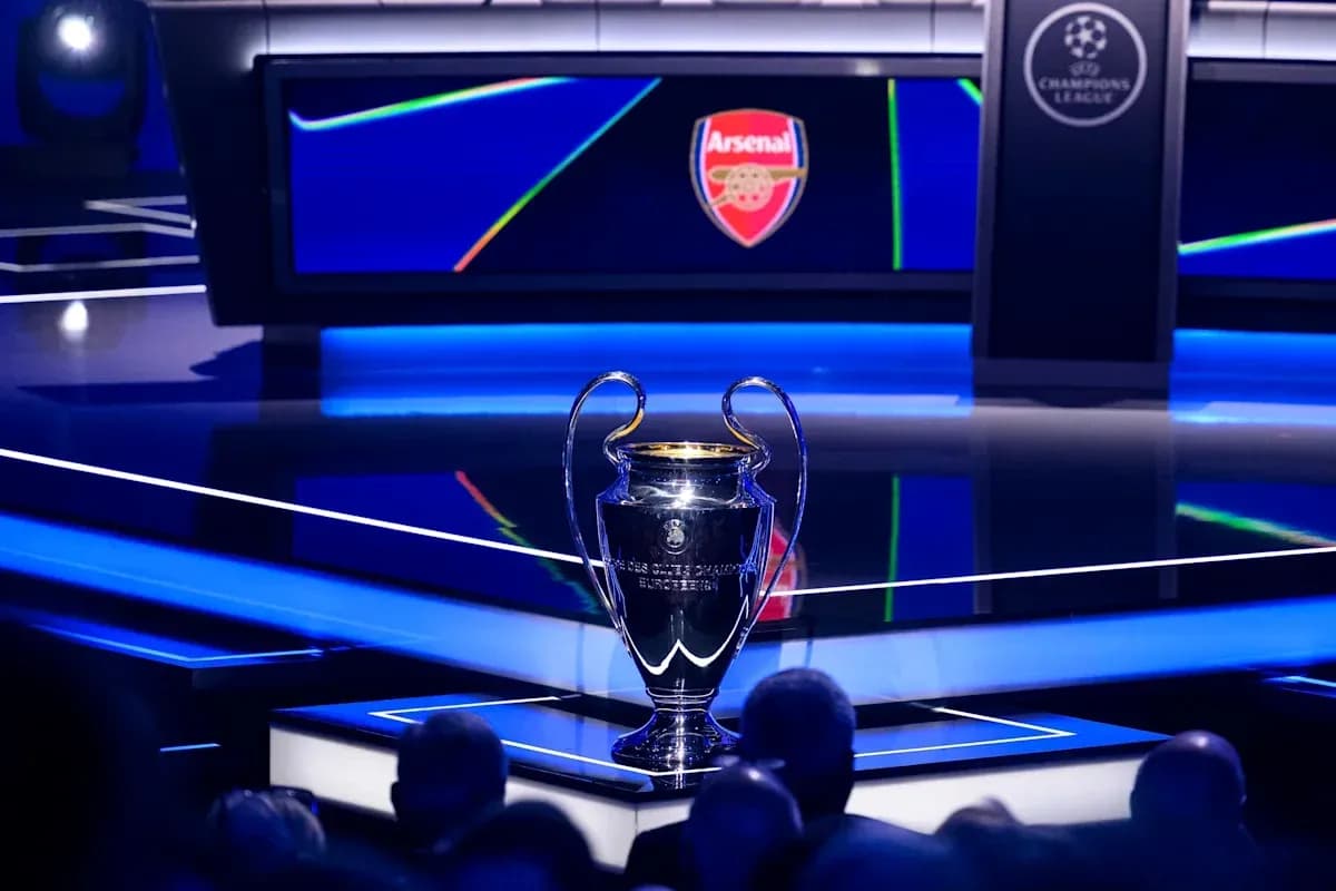 Champions League trophy with Arsenal logo in background