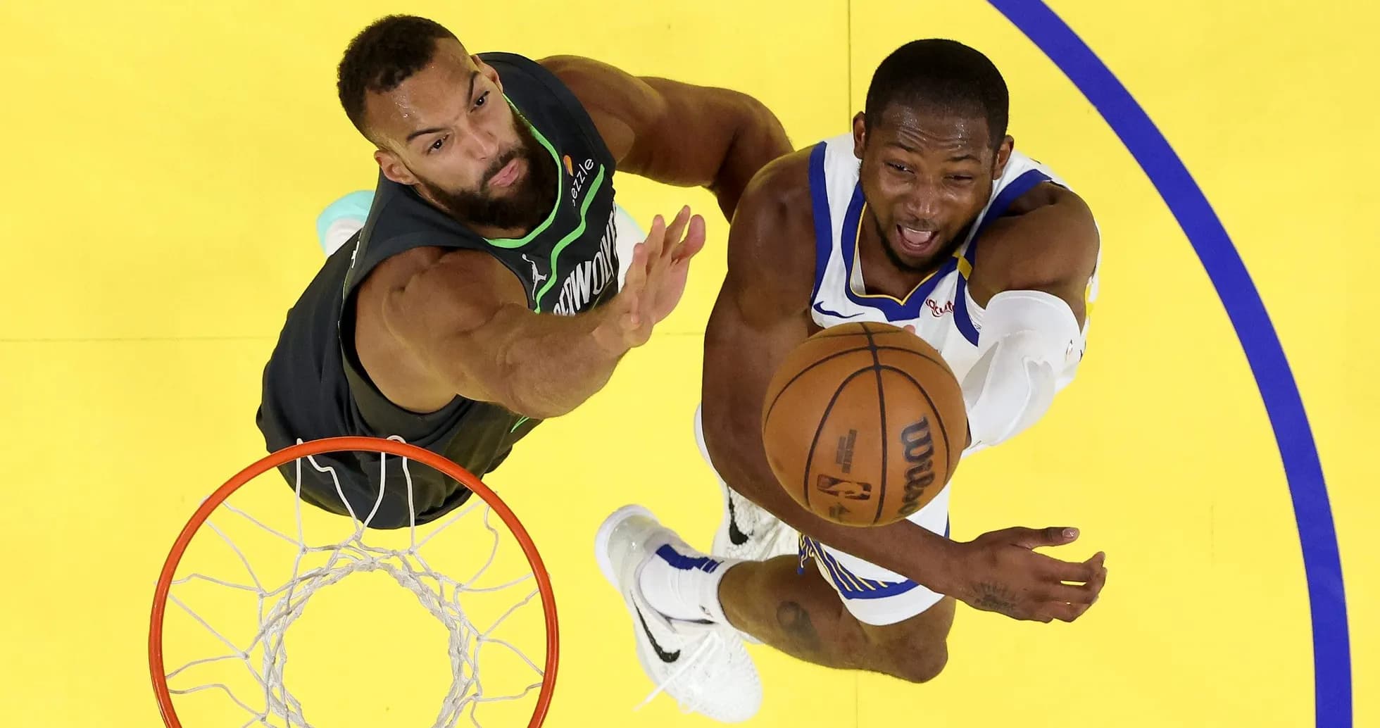 Player shooting the basketball while being defended