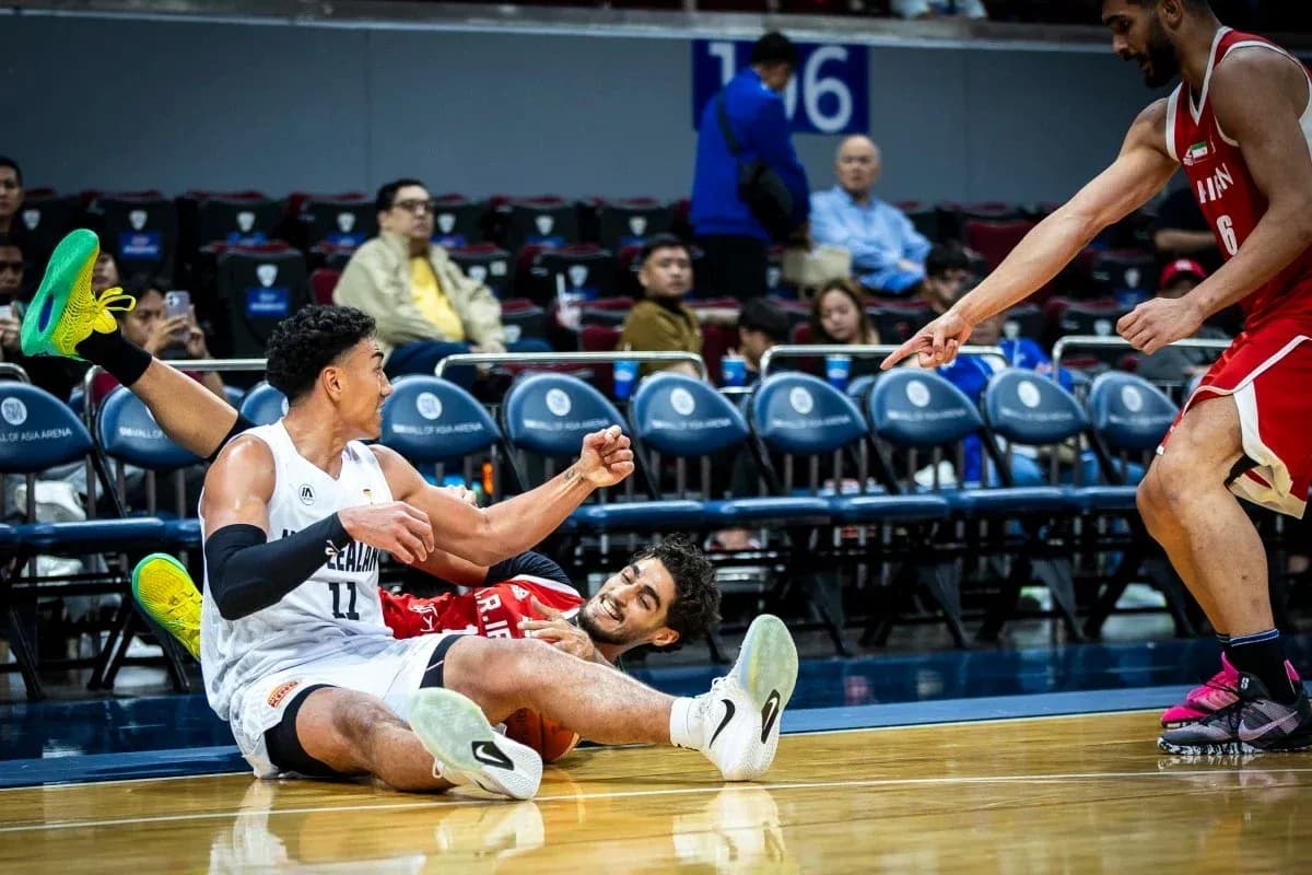 Two players on the floor during a basketball game