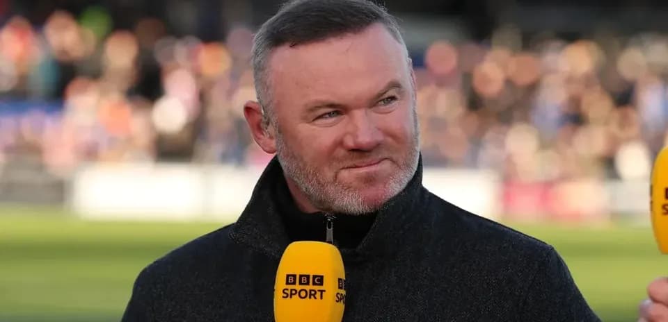 Sports analyst speaking with BBC Sport microphone