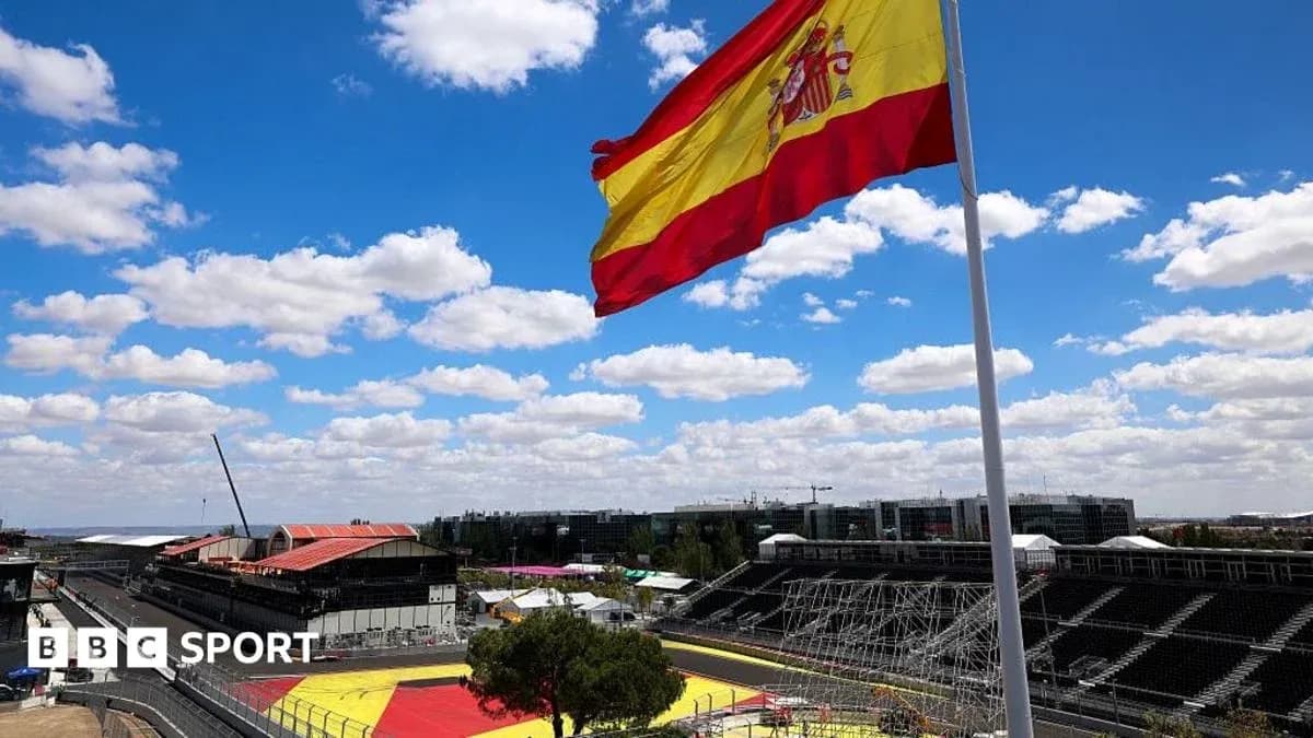 Spanish flag flying over racetrack under blue sky