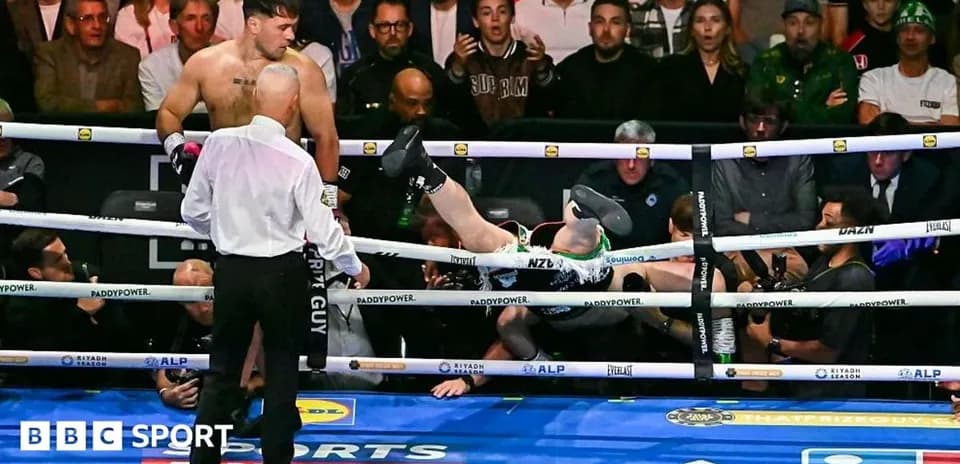 Boxer knocked out, falling out of the ring
