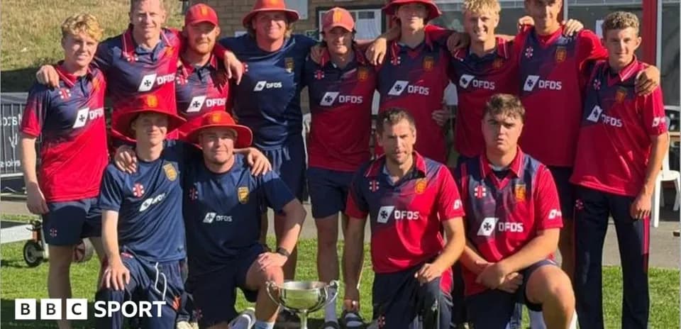 Cricket team posing with trophy after victory
