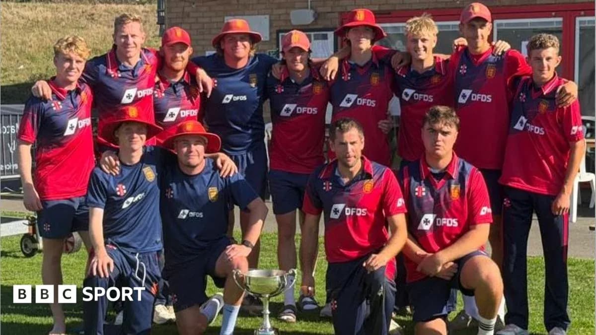Cricket team posing with trophy after victory