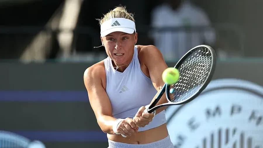 Tennis player hitting a forehand during match