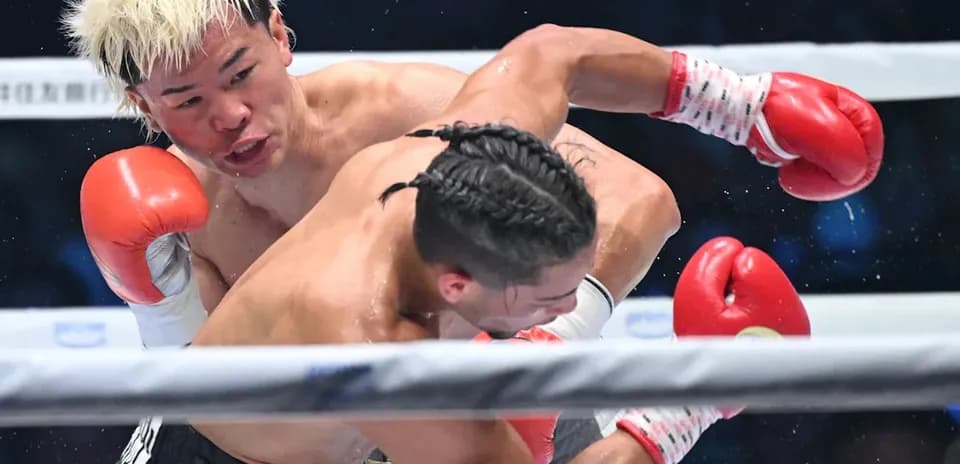 Boxer delivering a punch during match in ring