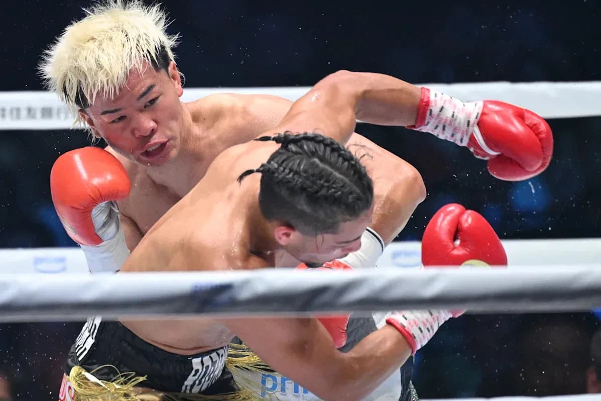 Boxer delivering a punch during match in ring