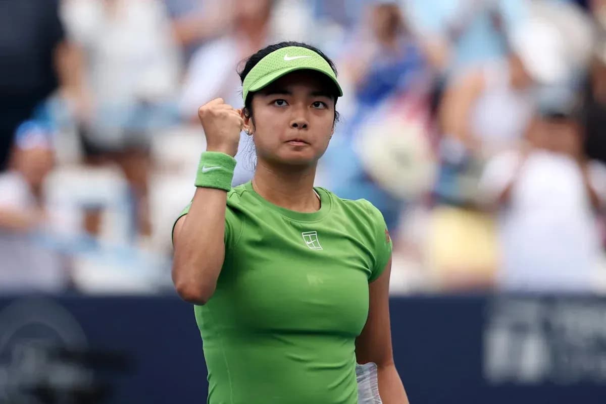 Tennis player celebrating a point in green outfit