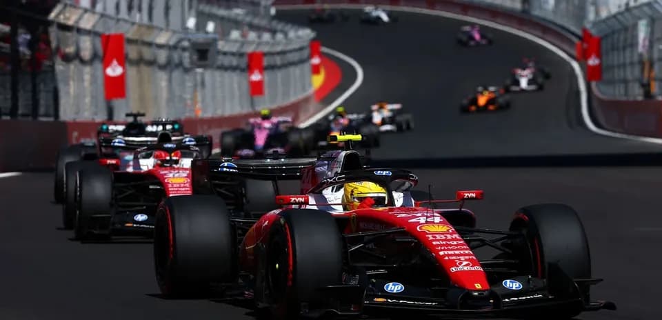 Ferrari car leading other Formula 1 cars on track
