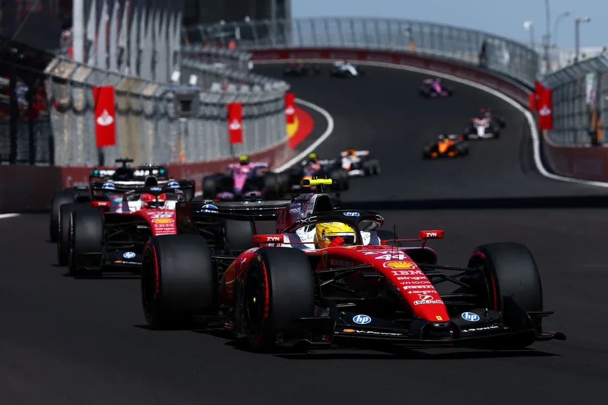 Ferrari car leading other Formula 1 cars on track