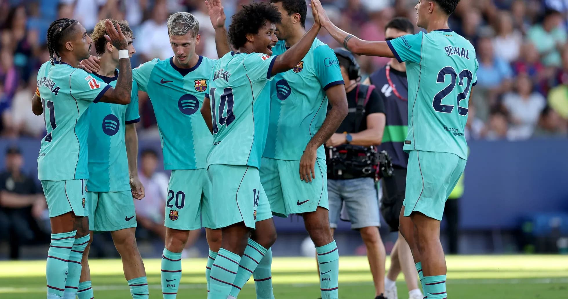 Barcelona players celebrating a goal on the pitch