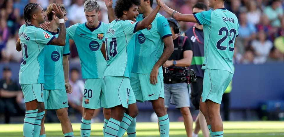 Barcelona players celebrating a goal on the pitch