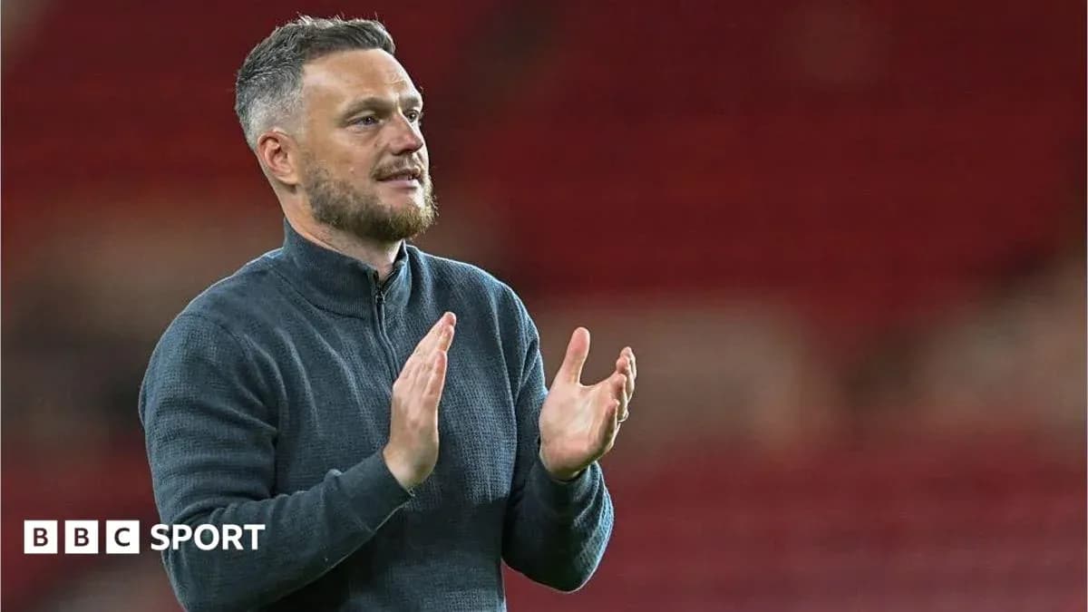 Coach applauding the crowd after the match