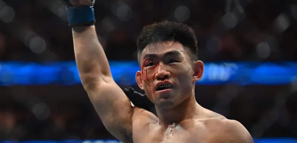 Fighter celebrating victory with blood on face