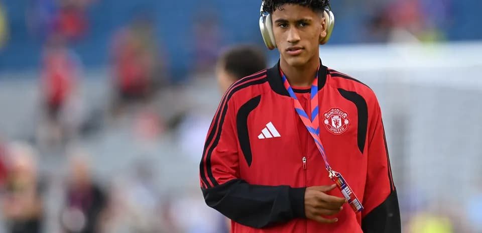 Player wearing headphones before match in training kit