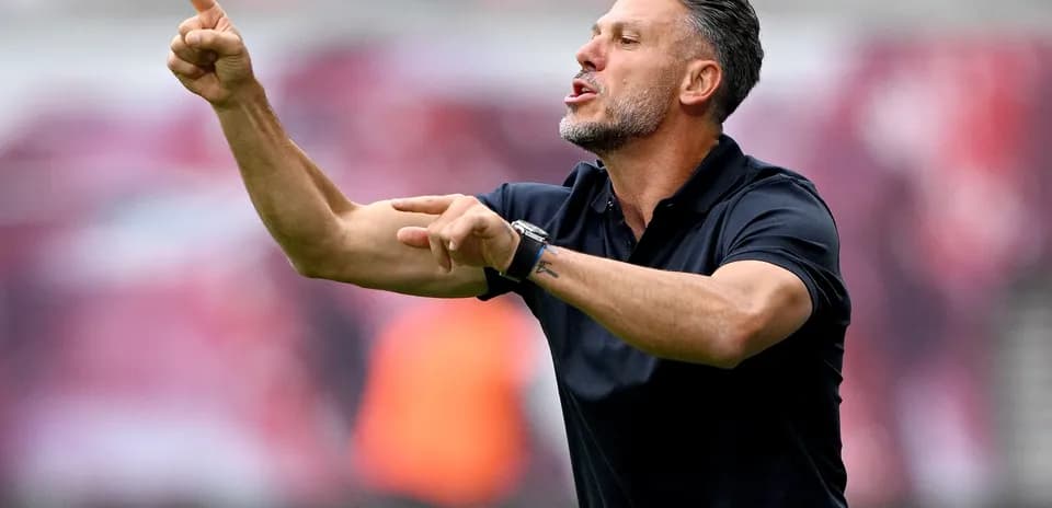 Coach giving instructions on the sidelines during match