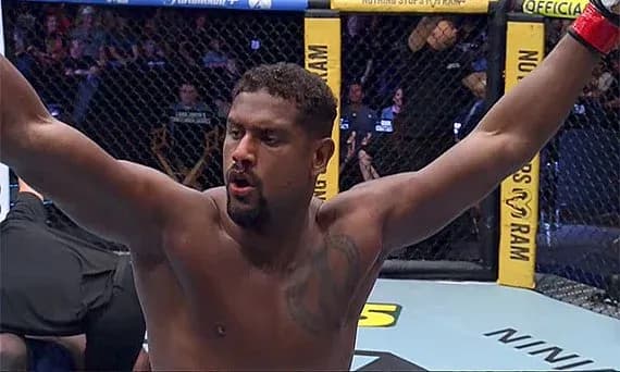 Fighter celebrating victory inside the octagon