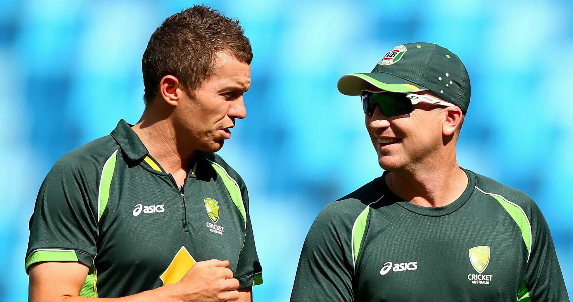 Two cricket players conversing during practice session