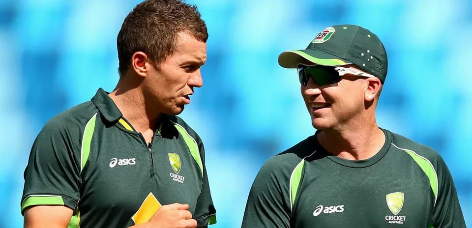 Two cricket players conversing during practice session