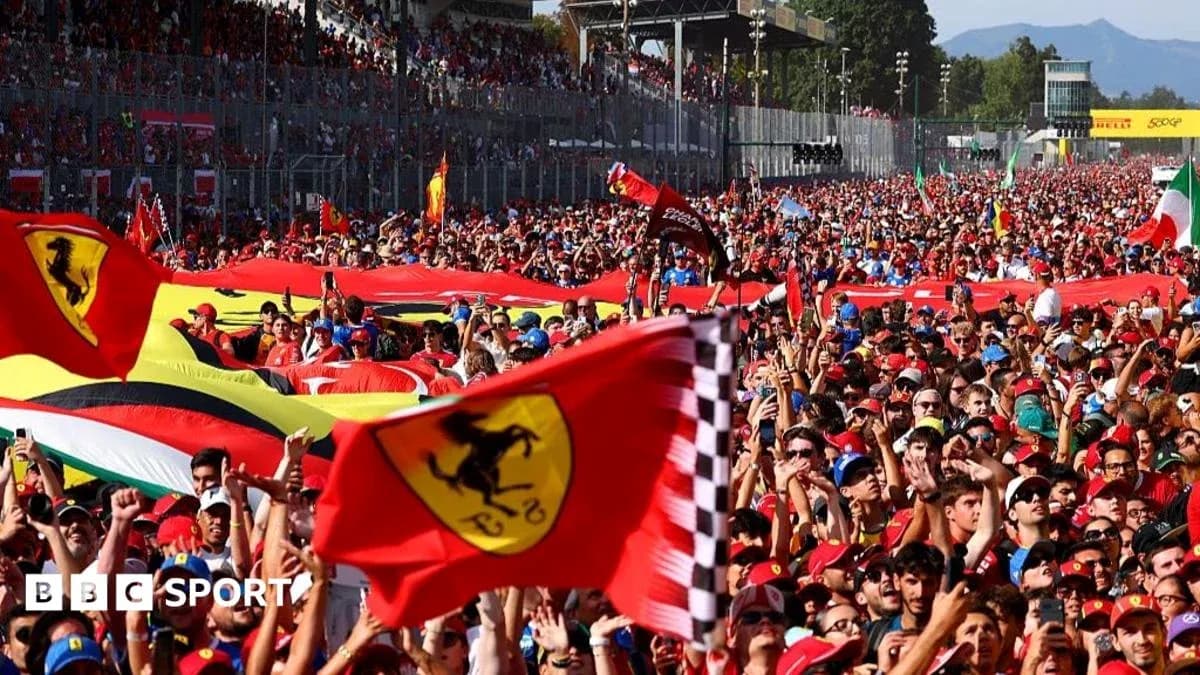 Large crowd of fans waving Ferrari flags at event