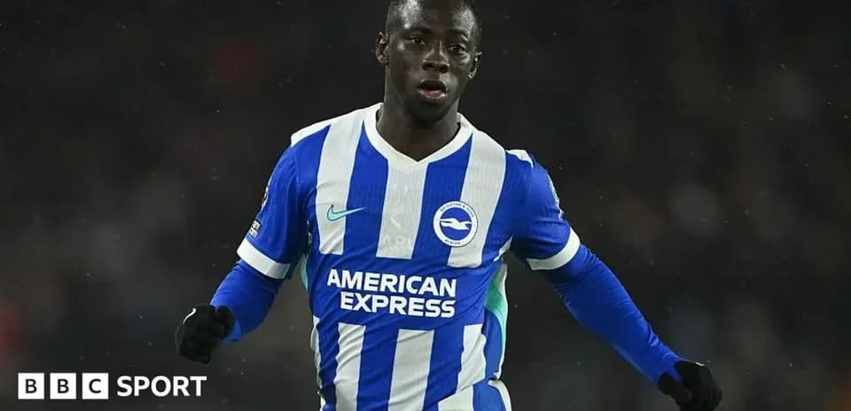 Player in blue and white kit celebrating during match