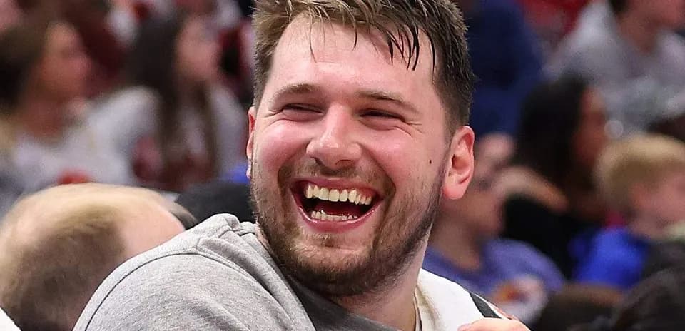 Player laughing on bench during basketball game